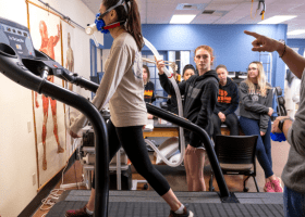 Female walking on treadmill.