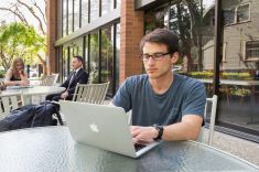 student sitting outside on Sacramento campus