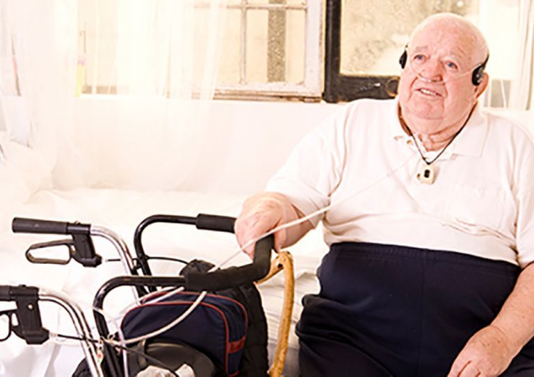 older man with assistive equipment