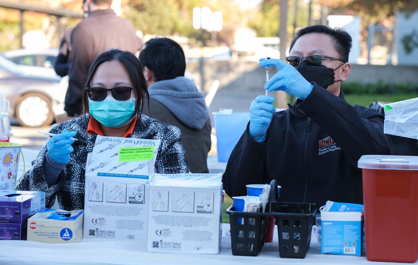 Pacific students volunteer at a COVID-19 vaccine clinic.