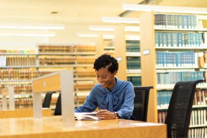 a student sits at a desk in the law library