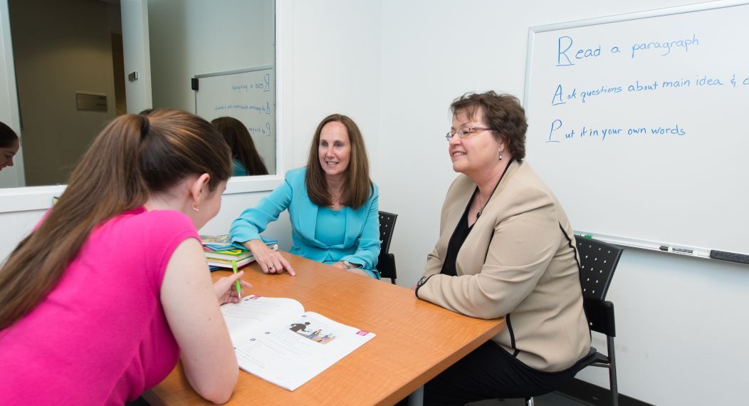 Professor Jeannene Ward-Lonergan and Associate Professor Jill Duthie, from the Department of Speech-Language Pathology and Audiology, work with a student in the new Language-Literacy Center, May 23, 2016.
