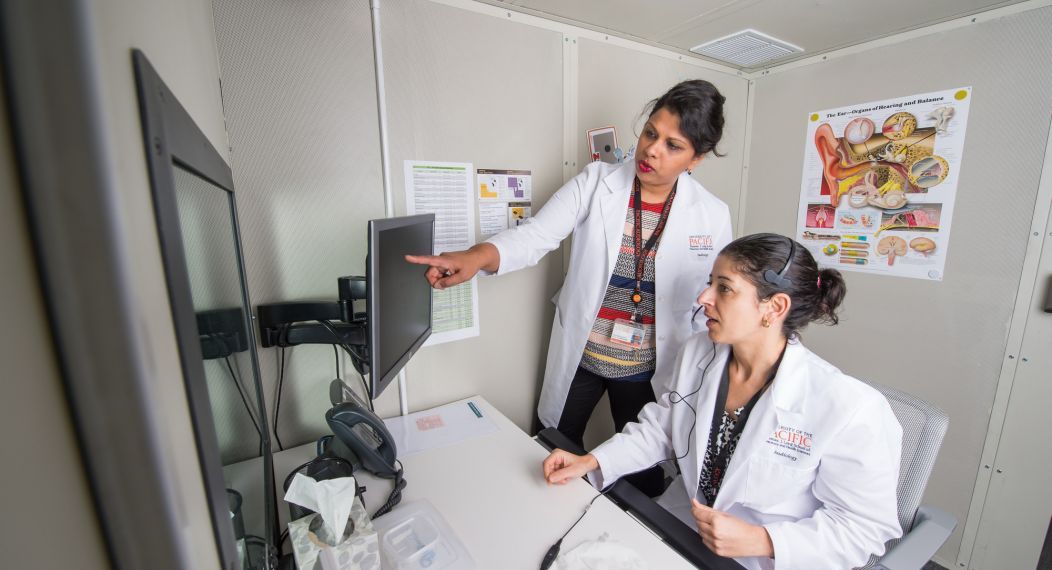 Rupa Balachandran, director of the doctor of audiology program in San Francisco, works along students in the clinic.
