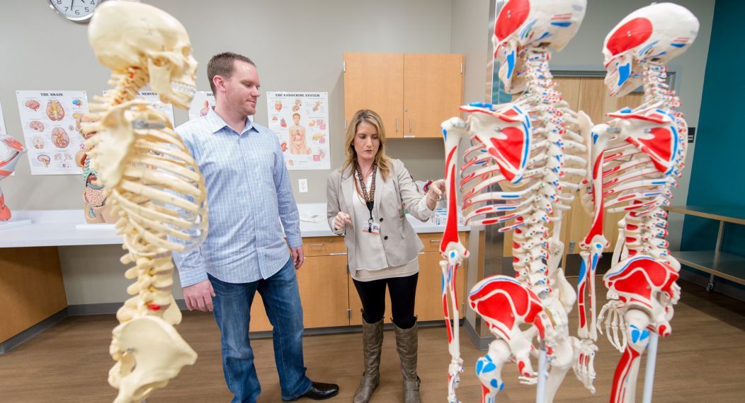 students with skeletons in lab