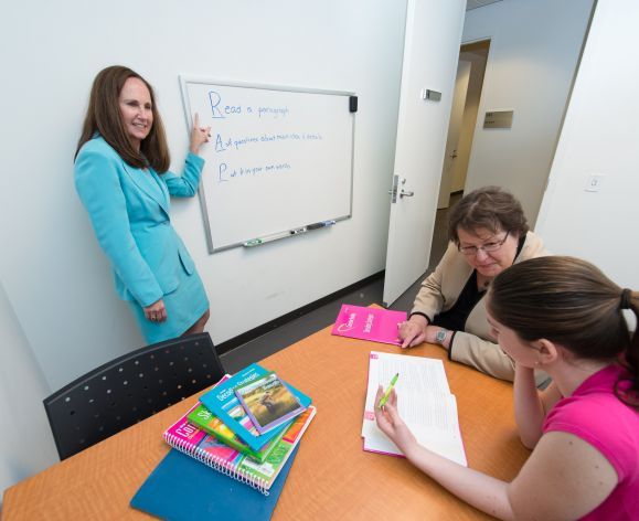 Professor Jeannene Ward-Lonergan and Associate Professor Jill Duthie, from the Department of Speech-Language Pathology and Audiology, work with a student in the Language-Literacy Center